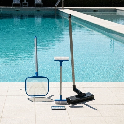 Various pool cleaning tools on a clean deck in Hyères