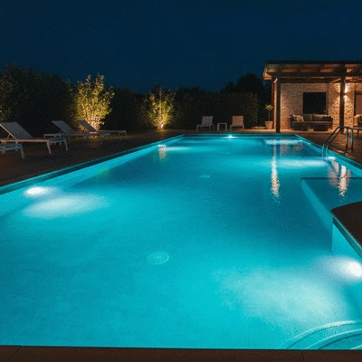 Modern LED pool lighting illuminating a swimming pool at night