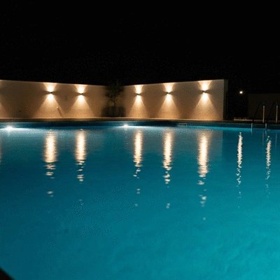Modern LED lighting integrated into a swimming pool at night, creating a warm and inviting atmosphere, no text, no words, no typography, clean image