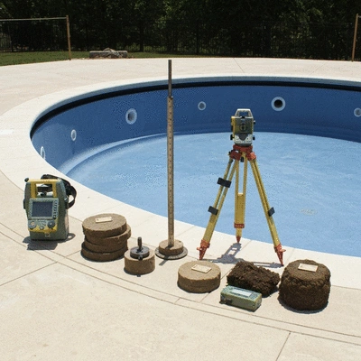 Geotechnical survey equipment on a construction site for a swimming pool, showing soil samples and measuring tools, professional and clean environment, no text, no words, no typography, clean image
